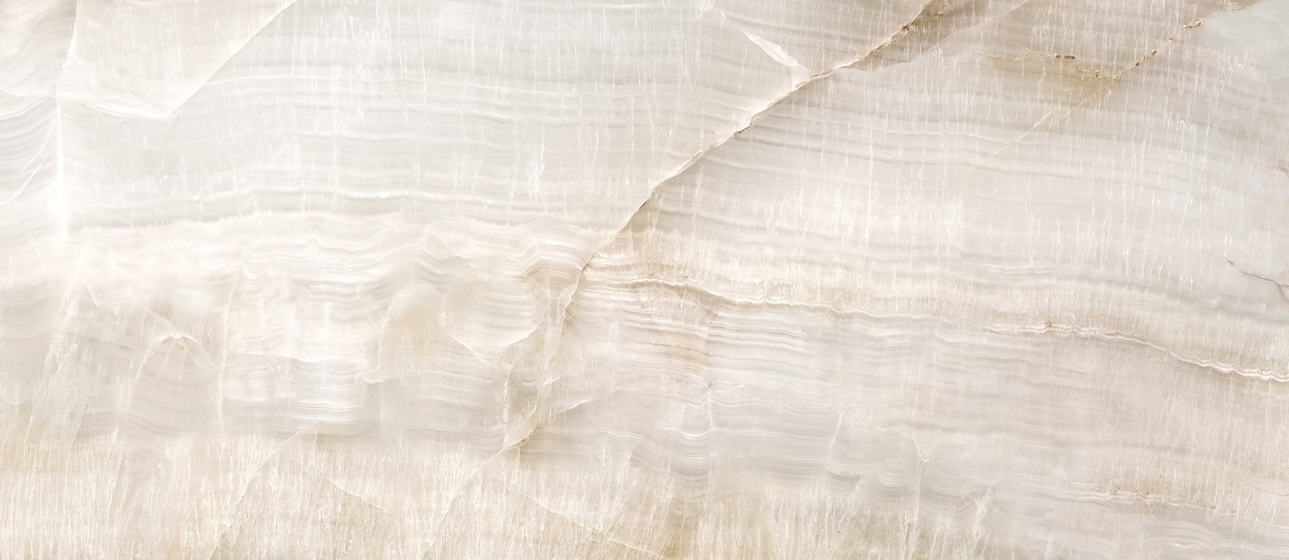 Smooth light-colored stone texture background.