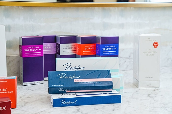 Cosmetic products arranged on a marble surface.