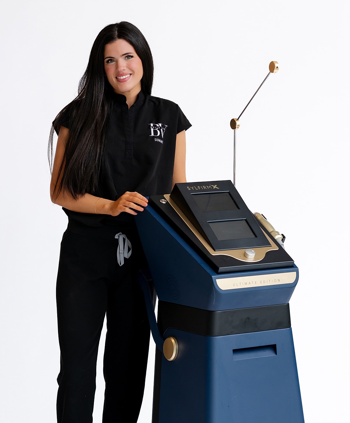 Woman beside advanced beauty treatment machine.