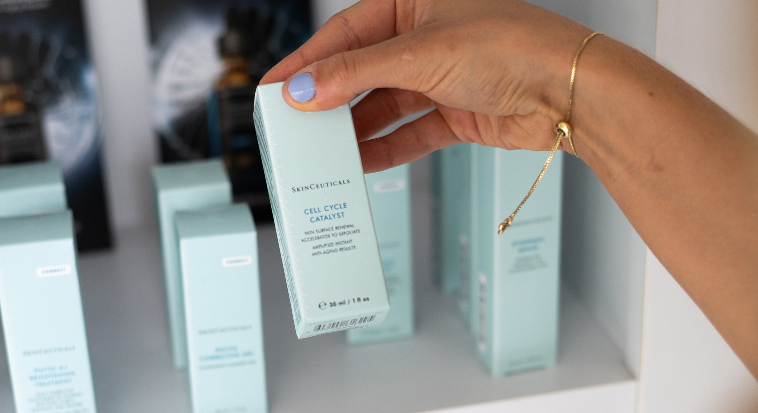 Hand holding SkinCeuticals Cell Cycle Catalyst product.