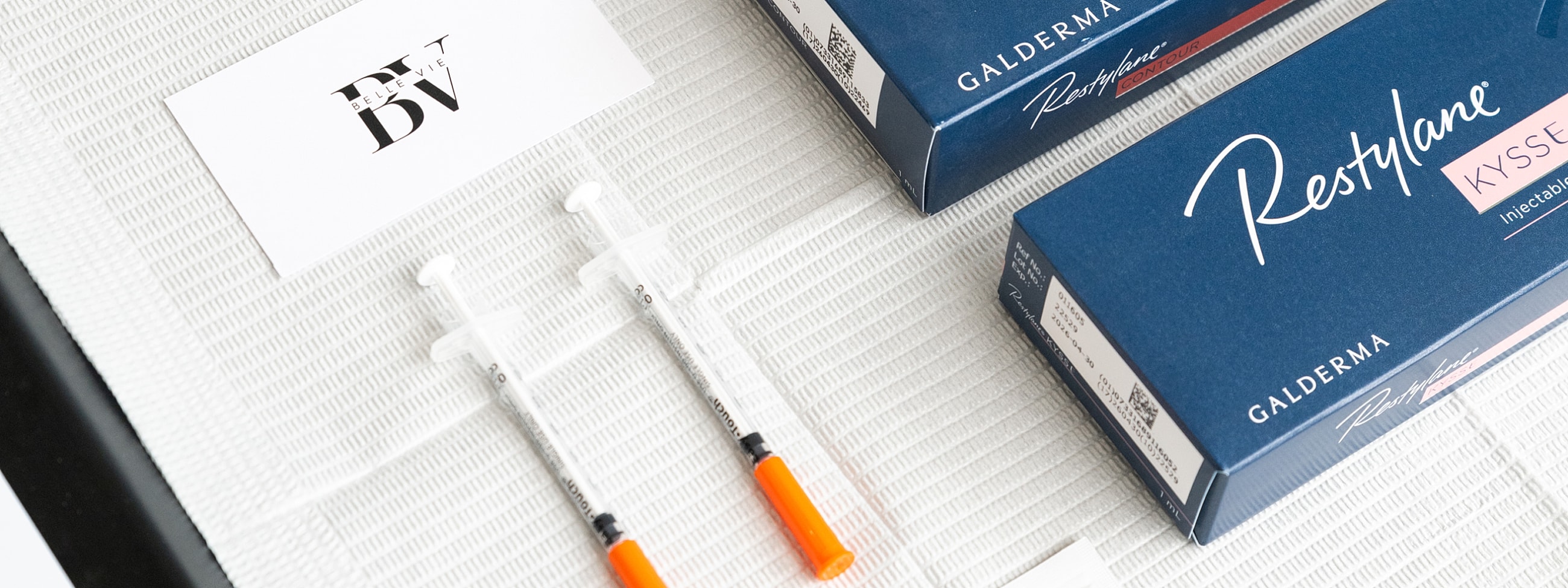 Syringes and Restylane boxes on a table