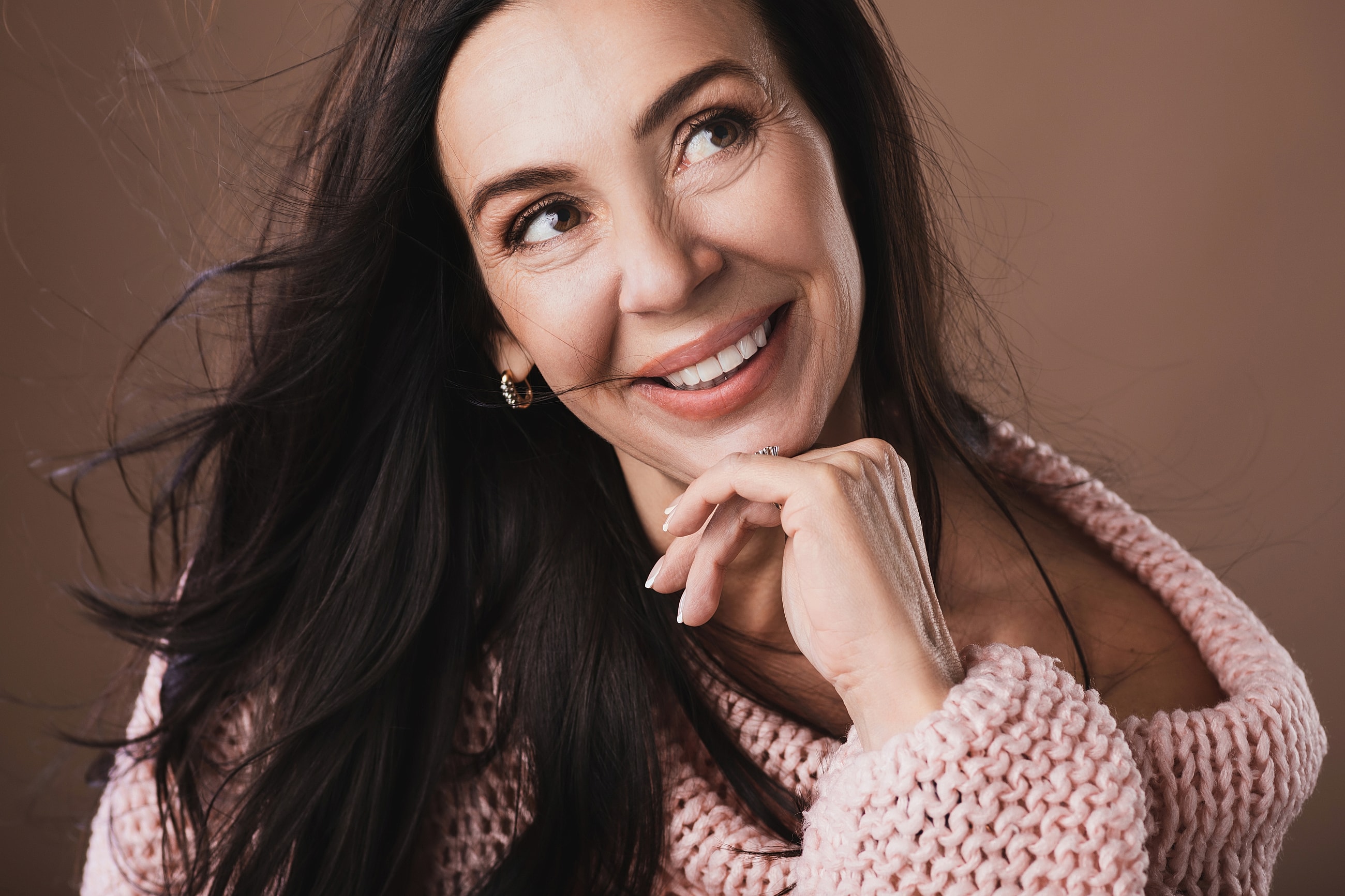 Smiling woman with long, flowing hair.