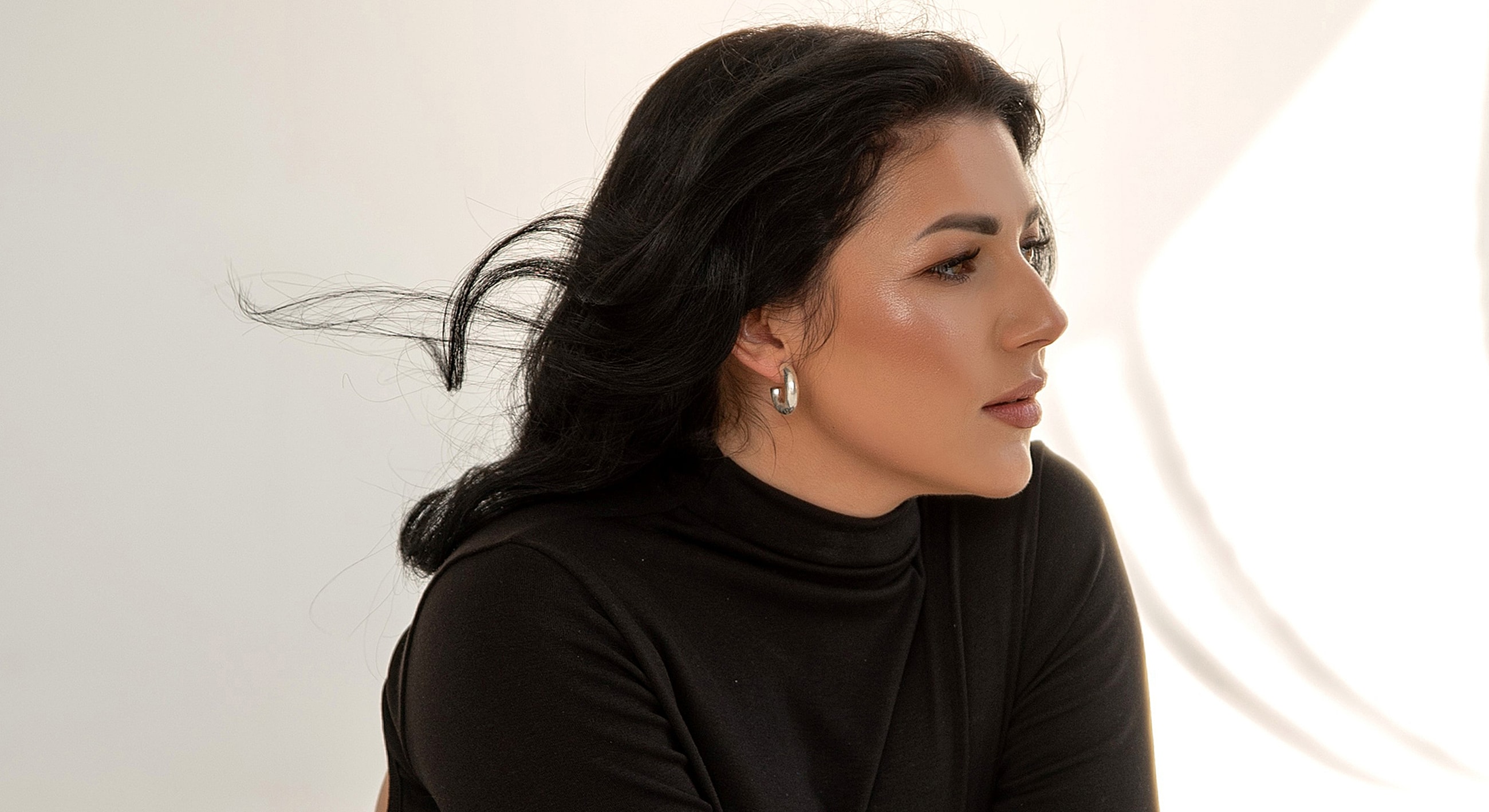 Profile of a woman with flowing hair.